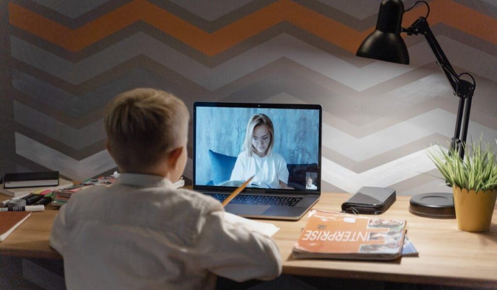 photo of boy looking at online tutor to learn french online